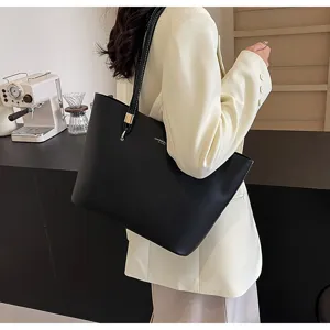 Detail view of a sleek black leather tote bag, perfect for daily commute and casual style.