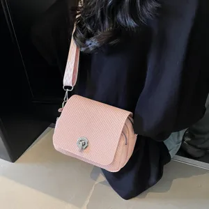 Pink mini woven crossbody bag for women, stylish shoulder bag with wide strap and lock closure.