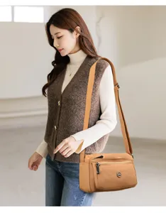 Detail view of solid color women shoulder bag, versatile crossbody bag with wide strap.