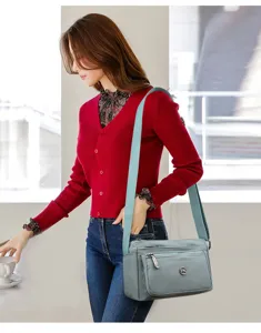 Detailed view of women solid color crossbody bag, casual nylon single shoulder commuting bag.