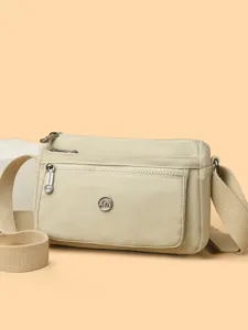 Solid color nylon crossbody bag for women, versatile large capacity shoulder bag for daily commute.