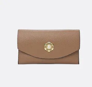 Elegant brown leather clutch wallet for women with pearl metal clasp, chic daily accessory.