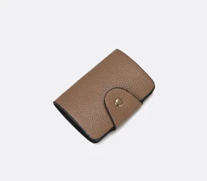 Brown leather card holder wallet with snap closure, minimal design for daily use.