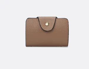 Brown leather small wallet card holder with snap button closure, compact minimalist design.