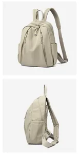 Detail view of the lightweight beige women backpack showing side pockets and metal hardware.