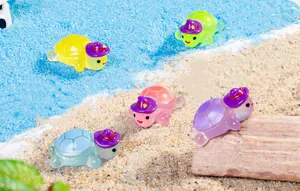 Glowing resin mini turtle charms with hats, ideal for DIY crafts and vivid desktop scene display.