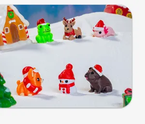 Detailed view of cute mini Christmas animal resin figurines on artificial snow decor.