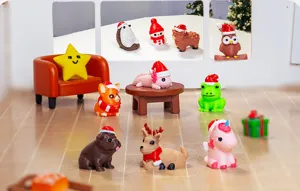 Close-up detail of cute Christmas miniature animal figurines wearing Santa hats for desktop decor.