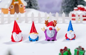 Detailed closeup of miniature Christmas gnome figurines, perfect for desktop holiday decor.
