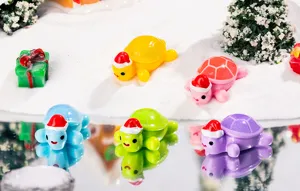 Close-up view of miniature resin turtles with Christmas hats, perfect for desktop holiday decoration.