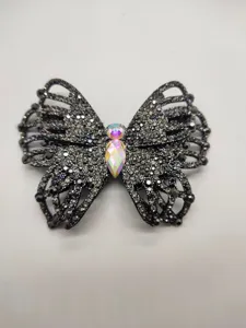 Close-up detail of butterfly rhinestone jewelry accessory with sparkling crystal gems.