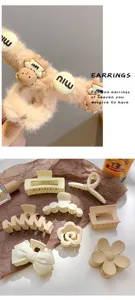 Brown plush hair claw clip set, cute bear charm design, stylish hair accessories for women.