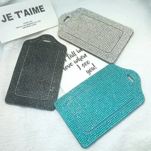 Close-up view of shimmering rhinestone id card holder and luggage tag details sparkling surface.