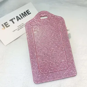 Close up detail of sparkling pink rhinestone PU leather ID badge and luggage tag surface.