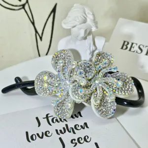 Sparkling rhinestone hair claw clip, elegant crystal flower design for women styling.