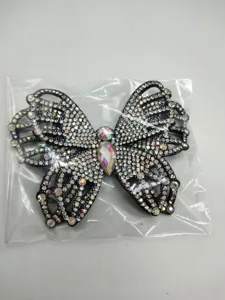 Rhinestone butterfly hair accessory detail, shiny crystal rhinestone hairpin embellishment.