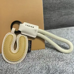 stylish letter U leather keychain and cute bag charm accessory for daily use and gifts.
