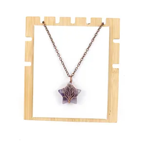Natural amethyst crystal star wire wrapped tree of life pendant necklace with copper chain display.