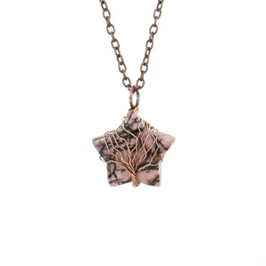 Close up detail shot of a natural stone star wire wrapped tree of life pendant necklace.