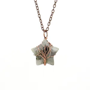 Close-up of a handmade wire-wrapped crystal star pendant necklace with copper chain.