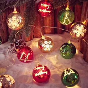 LED Christmas string lights with festive balls, snowflake and tree patterns for holiday decor.