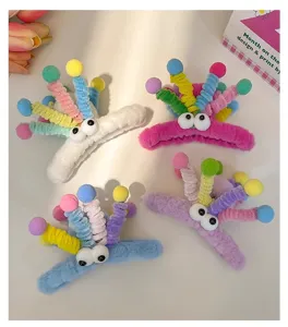 Cute plush hair claw clip with colorful pom poms and funny googly eyes, dopamine style.