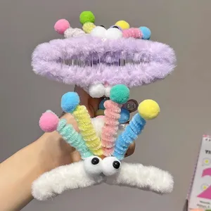 Cute plush hair claw clip with colorful pom poms and funny eyes, trendy dopamine style.