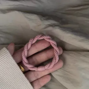 Minimalist pink braided elastic hair tie for women, chic daily hair accessory band.
