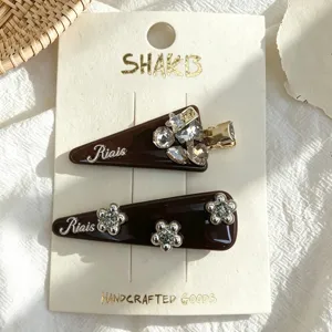 Elegant brown triangle hair clips set with sparkling rhinestones and delicate flowers for women.