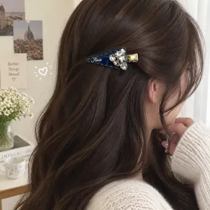 Side profile detail of elegant dark blue denim rhinestone triangle hair clip worn in hair
