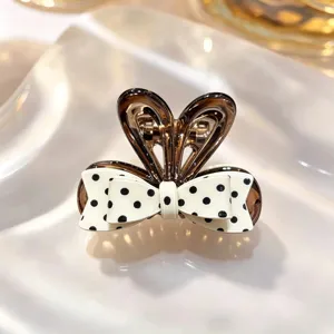 Chic Korean black and white polka dot hair claw clip, stylish bow hair accessory for daily wear.
