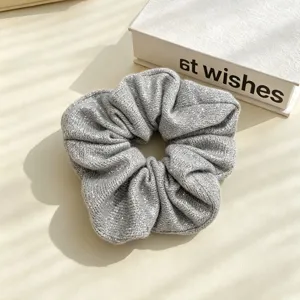 Silver glitter scrunchie close-up, sparkly knit hair tie detail, chic daily hair accessory.