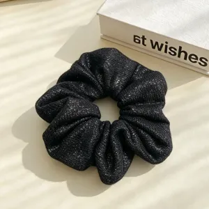 Black sparkly scrunchie for women, elegant glitter hair tie, elastic ponytail holder style.