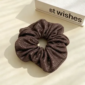 Detailed view of brown metallic silk scrunchie, glossy hair tie for stylish lazy ponytails.
