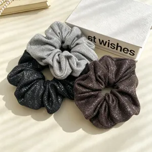 Details of the elegant sparkling glitter hair scrunchies set in black, silver and brown.