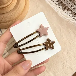 Charming star hair clips detail shot, cute polka dot design, versatile side clip accessory.