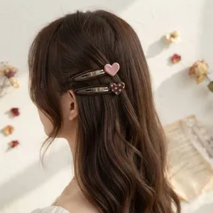 Charming heart hair clips featuring pink and brown polka dot designs for sweet daily wear.
