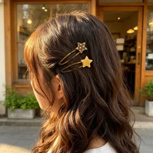 Detailed shot of cute star hair clips with polka dots, stylish side bobby pins worn on wavy hair.