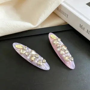 Exquisite Korean style hair clip detail featuring sparkling rhinestones and pearls on chic design.
