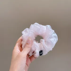 Pink organza scrunchie hair tie, shiny sheer fabric hair accessory for elegant daily styling.
