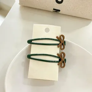 Cute green metal BB clips with brown bow design, perfect side hair accessories for women.