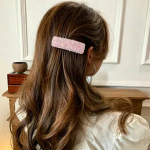 Detail view of the pink crystal rhinestone hair clip, showcasing sparkling texture and design.