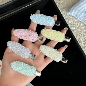Detailed close-up of colorful crystal rhinestone hair clips, sparkling hairpin side clips.