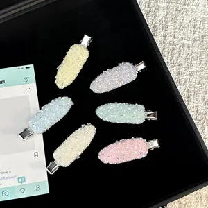 Detailed close-up of pastel crystal hair clips set featuring sparkling rhinestones on tray.