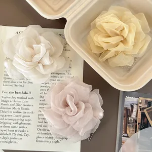 Exquisite chiffon camellia flower hair comb with pearl detail, elegant sweet style accessory.