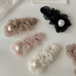 Detailed shot of Korean mesh hair clips with large faux pearls in various stylish colors.
