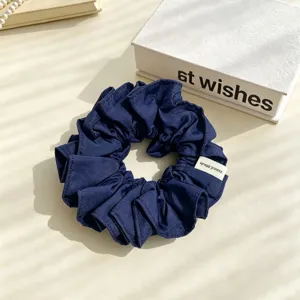 Dark blue pleated fabric hair scrunchie, soft elastic ponytail holder daily hair accessory.