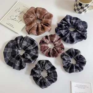 Close-up detail showcasing the soft texture and plaid pattern of retro hair scrunchies.