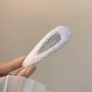 Rhinestone teardrop snap hair clip detail, sparkling glitter finish for cute styling.