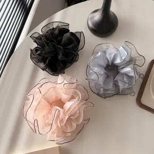 Close-up detail of Korean style fine glitter lace large hair scrunchies, elegant hair accessory.